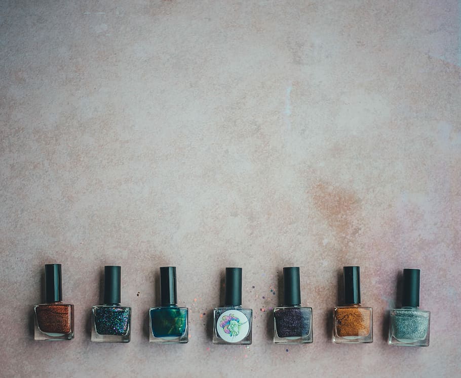 Nail varnish / nail polish, seven assorted-color nail polish bottles on gray surface, HD wallpaper
