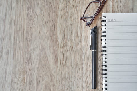 pen beside notebook and eyeglass on wooden surface, eyewear HD wallpaper