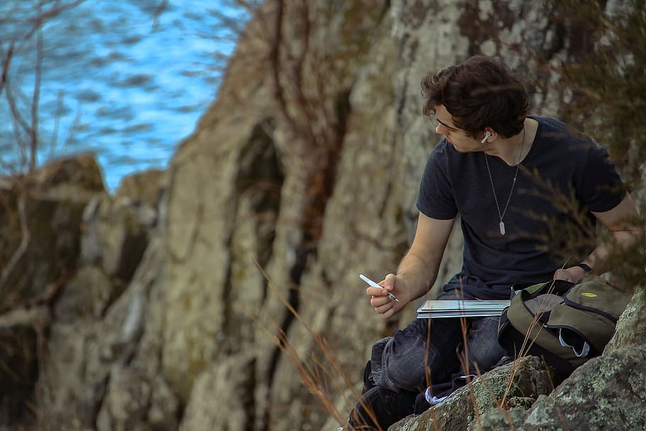 man holding ballpoint pen, man writing on top of the mountain near sea at daytime, HD wallpaper