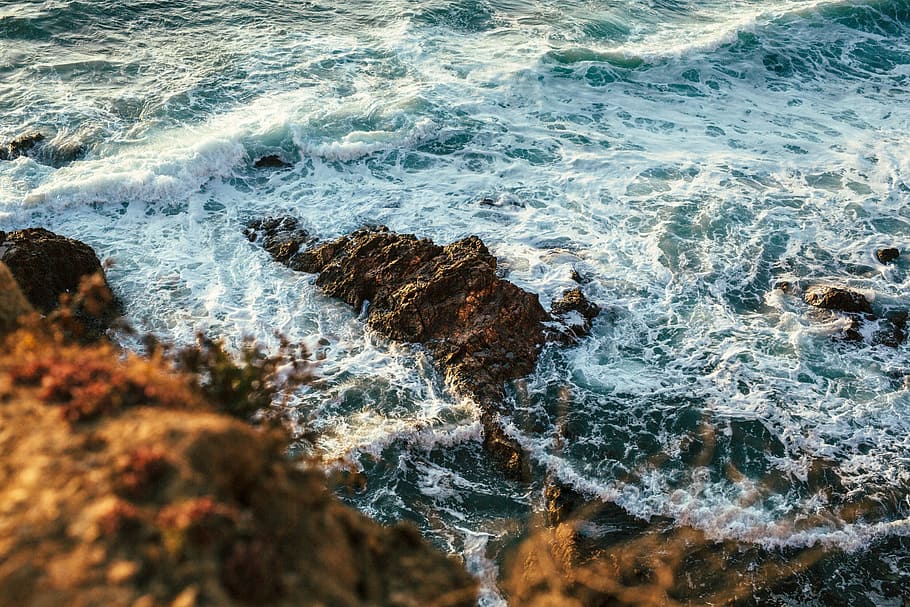 aerial photography of seashore, rocky seashore with sea wave at daytime HD wallpaper
