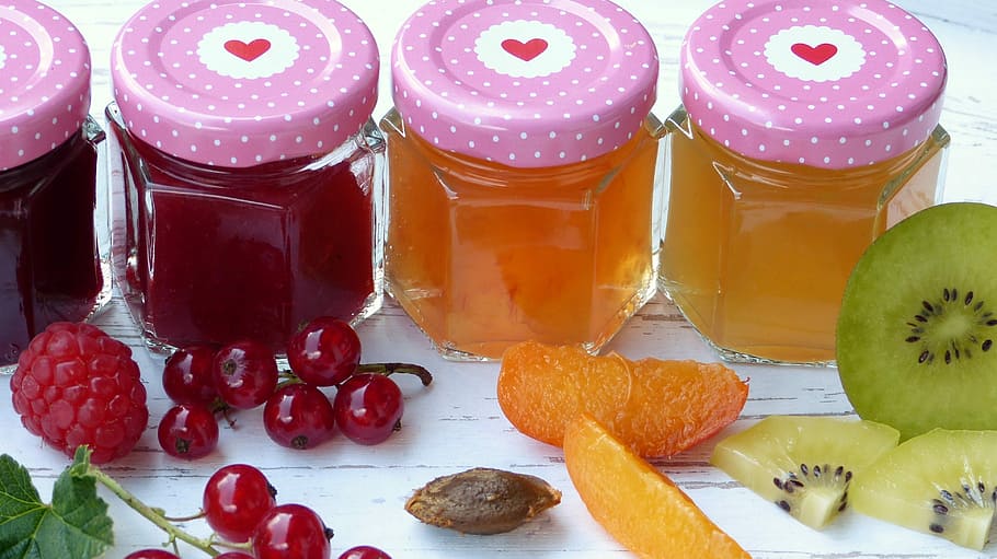 several fruit juices inside clear glass jars, jam, fruits, sugar