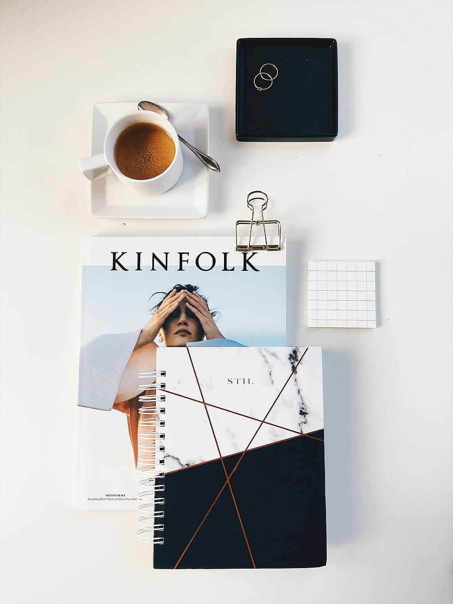 flat lay photography of cup, rings, and notebook, poured teacup on saucer beside spoon HD wallpaper