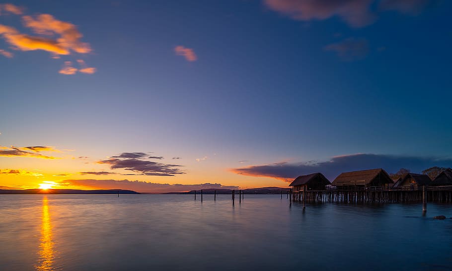 brown hut in the middle of body of water, sunset, waters, dusk HD wallpaper