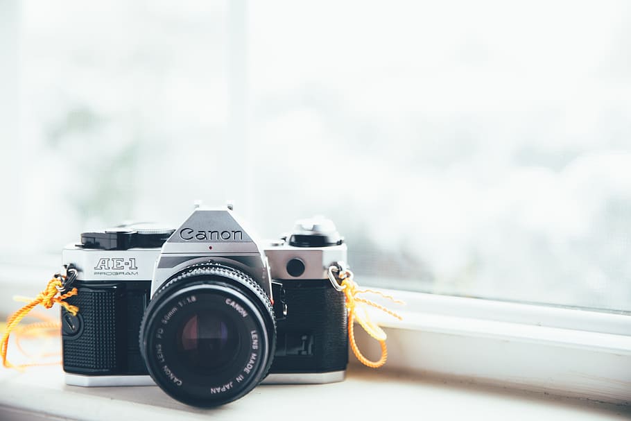 Canon SLR camera on window, gray and black Canon DSLR camera in front of window HD wallpaper
