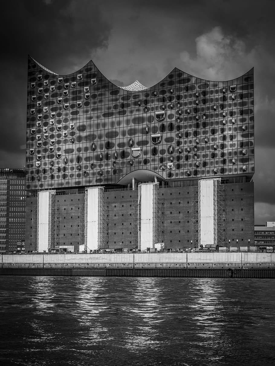 grayscale photography of building beside body of water, city