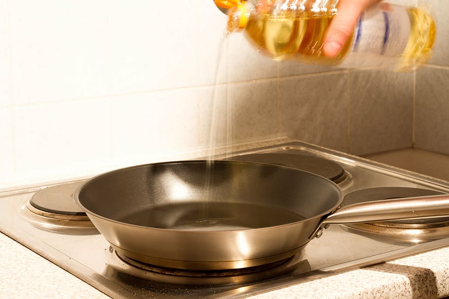 person pouring oil in frying pan, kitchen, heat, sear, cook, fat, HD wallpaper