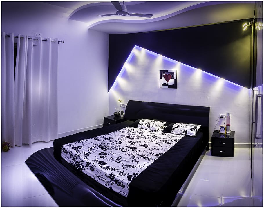 lighted black framed bed with floral bedding set, bedroom, theatre lights