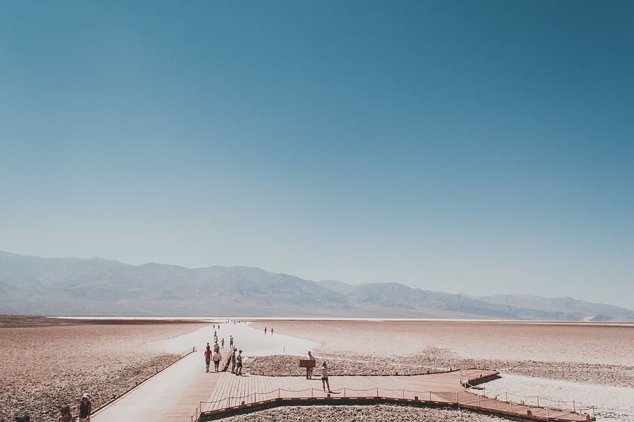 people walking on path towards mountains, aerial photo of people on brown wooden dock during day HD wallpaper