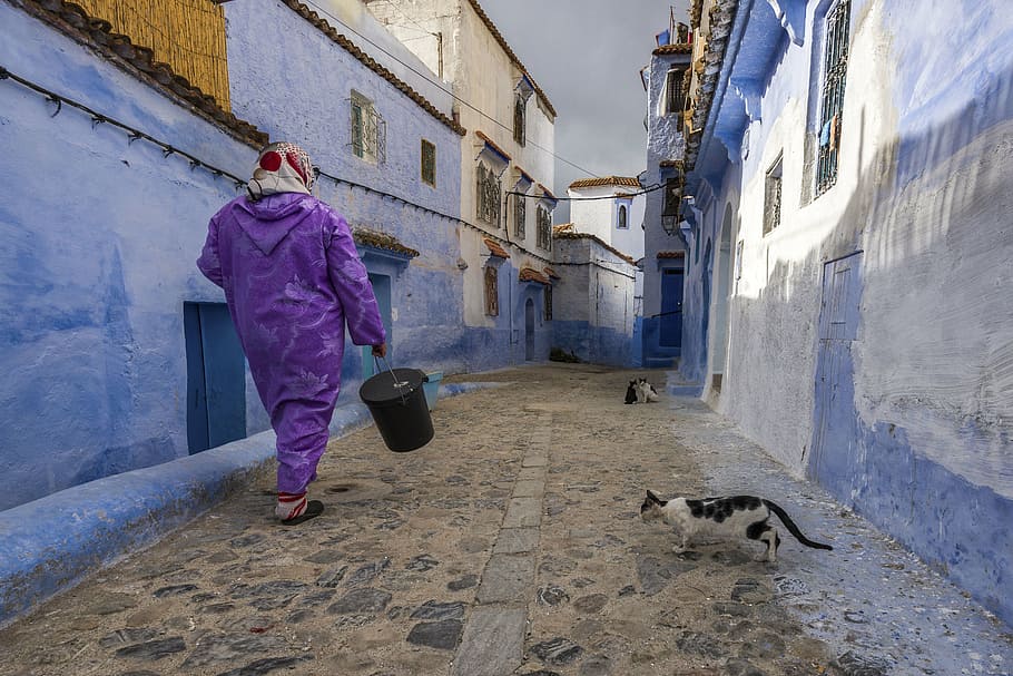 person carrying bucket on village hallway, architecture, building