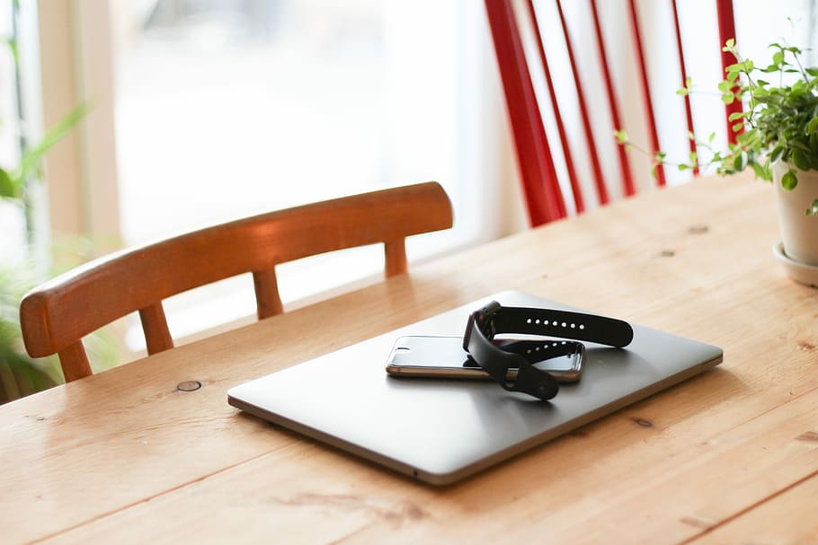 black watch on top of smartphone and laptop, smartphone on laptop compute HD wallpaper