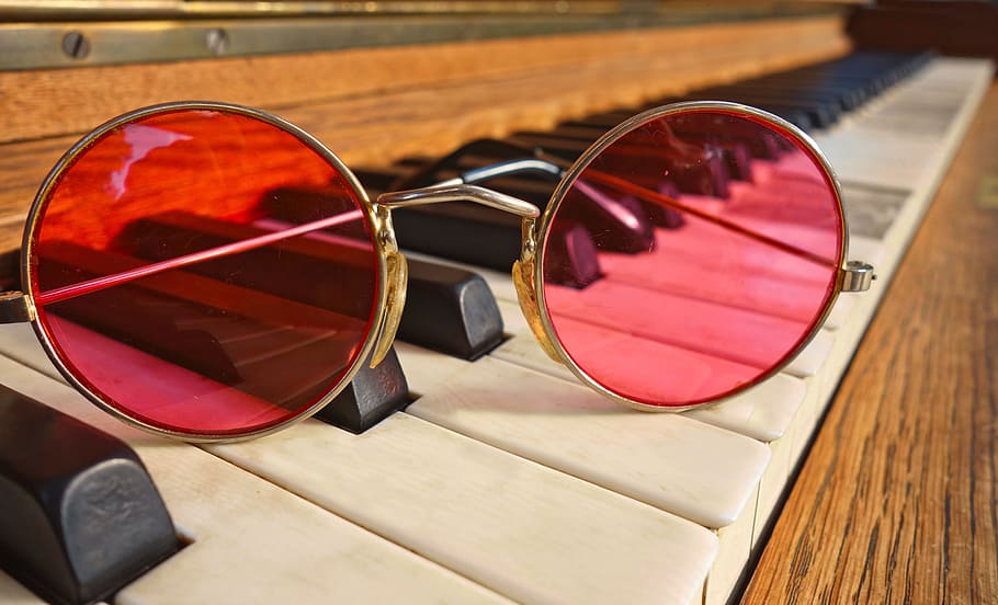 red round sunglasses with gold-colored frame on top of brown piano HD wallpaper