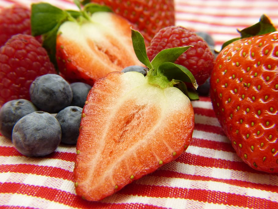 closeup photo of pile of strawberries and blueberries, raspberries