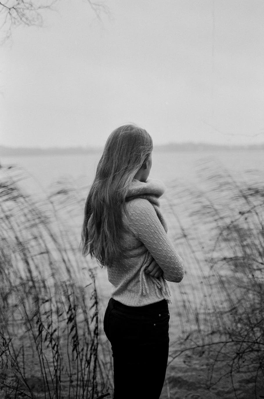 grayscale photo of woman standing near body of water, gray scale photo of a woman in long-sleeved top, HD wallpaper