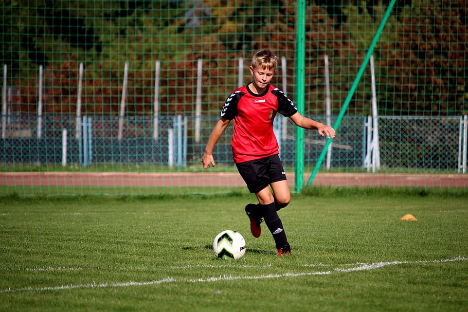 boy playing soccer on soccer field, football, player, players