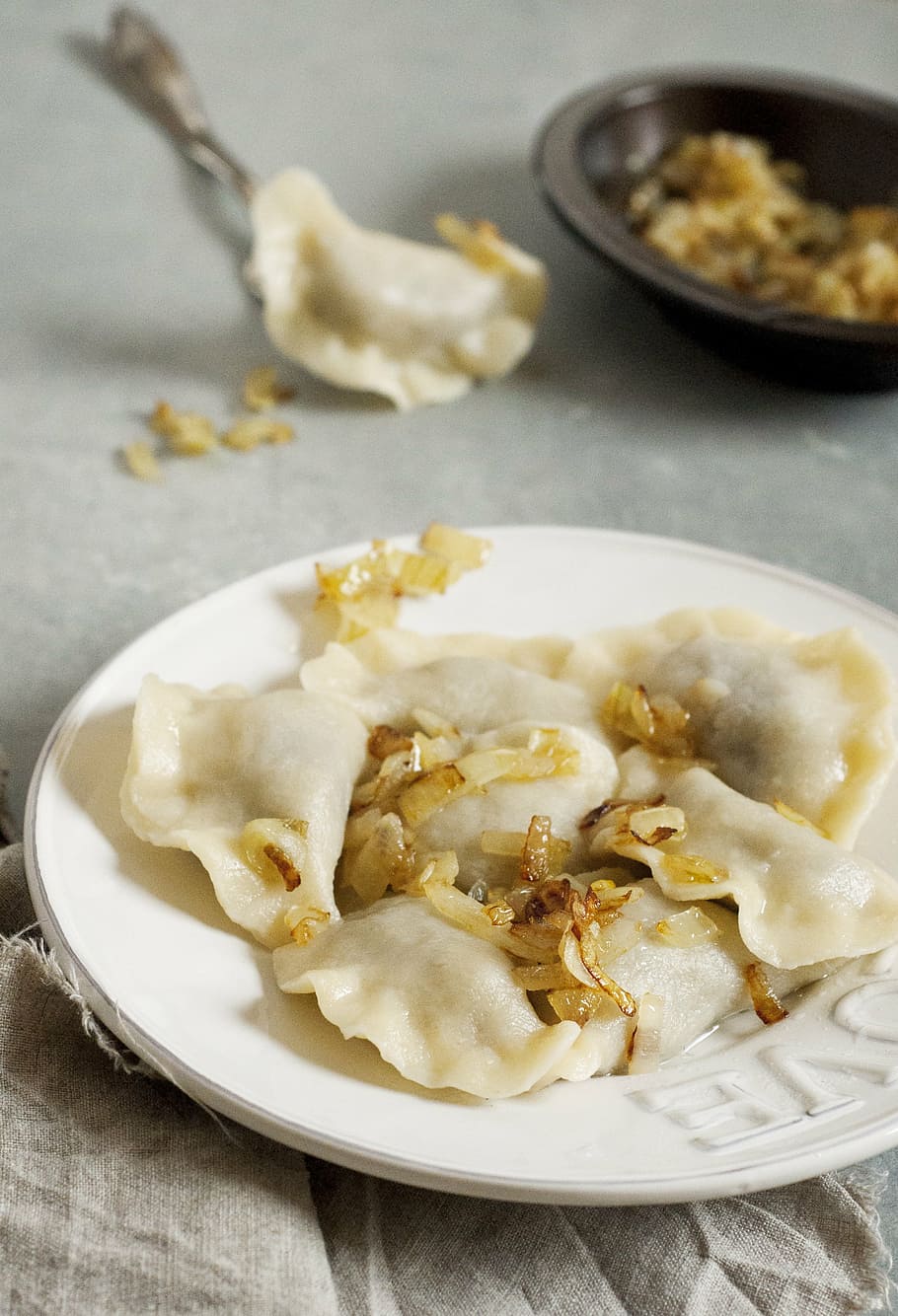 steamed dumplings on plate, slavic cuisine, filling, pierogi ruskie