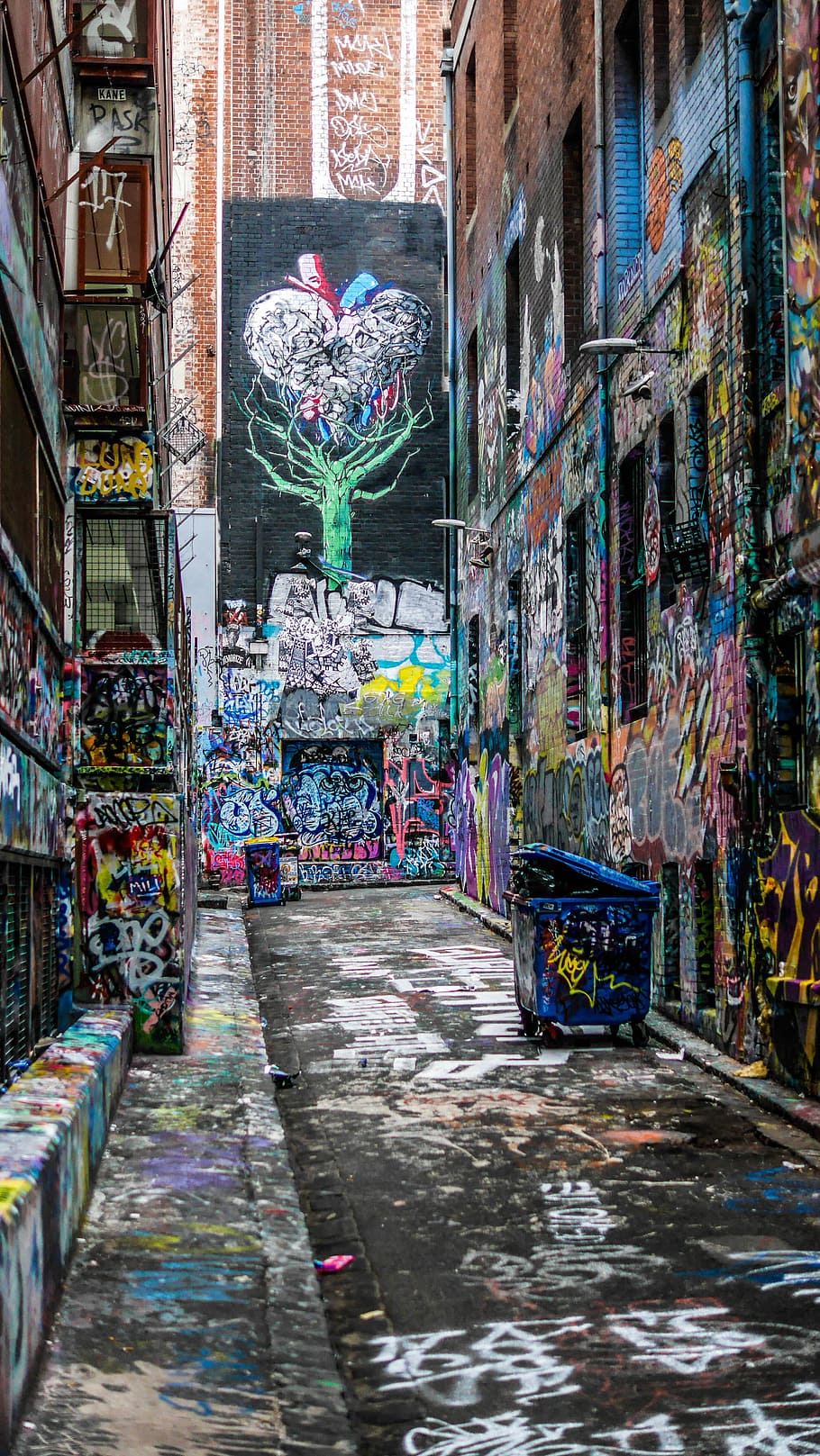 graffiti wall alley during daytime, photo of wall graffiti, street art