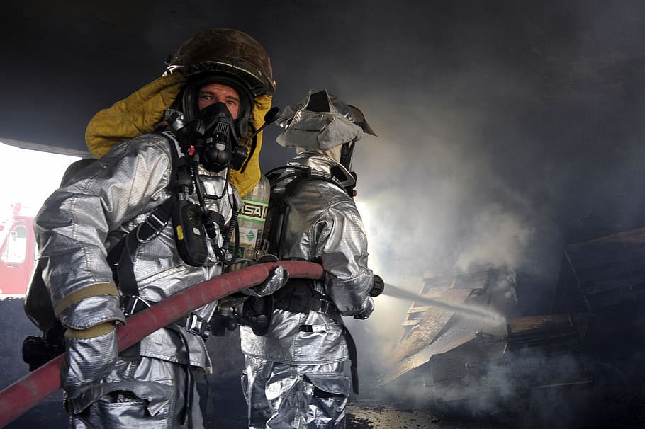 two firefighters holding hose, firemen, flames, smoke, water