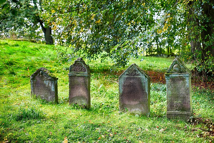 four gray concrete graves, cemetery, grave stones, old cemetery