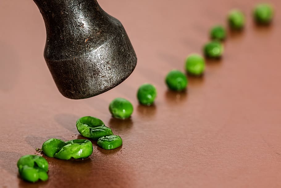 lined green peas on brown surface, fear, domination, bully, victim