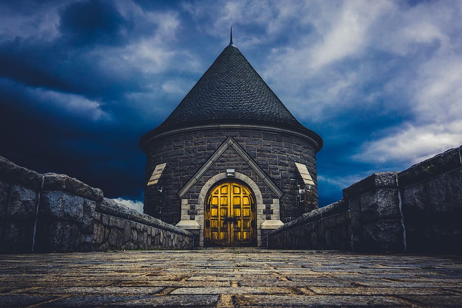 pathway leading to tower, gray stone building with finial, architecture