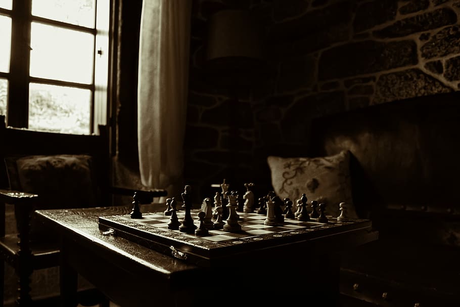 chessboard on table beside window, chessboard set on table inside room