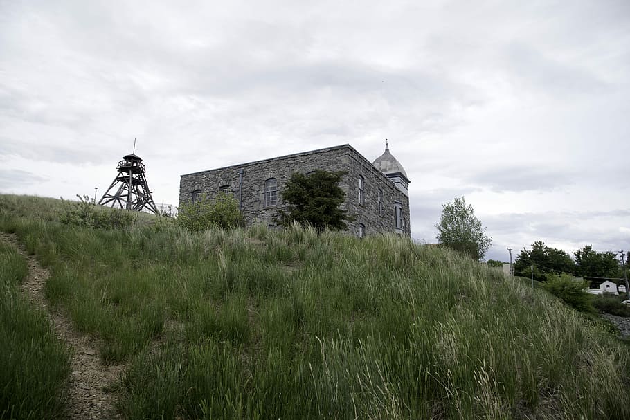 Fire tower and stone building perched on a hill in Helena, clouds HD wallpaper