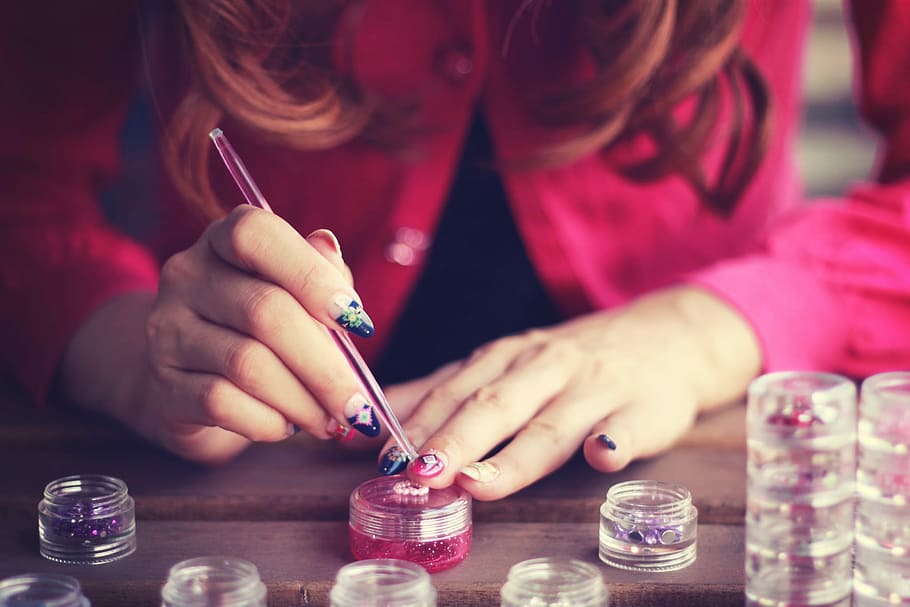 woman coloring her nail on brown wooden table, people, human Hand HD wallpaper
