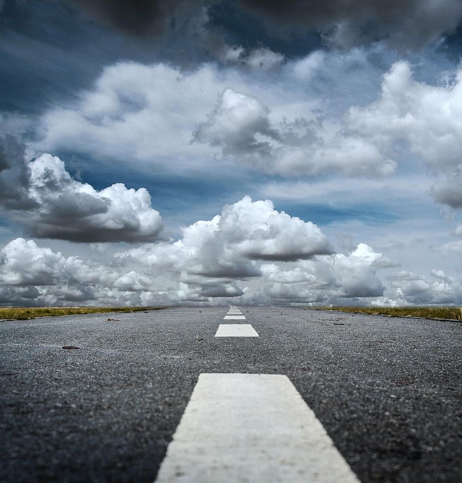 low angle photography of pathway under clouds, seat belts, direction