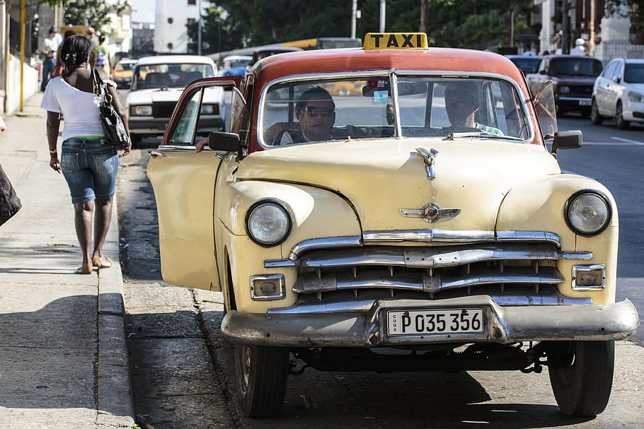 two men inside taxicab beside sidewalk near vehicles during day HD wallpaper