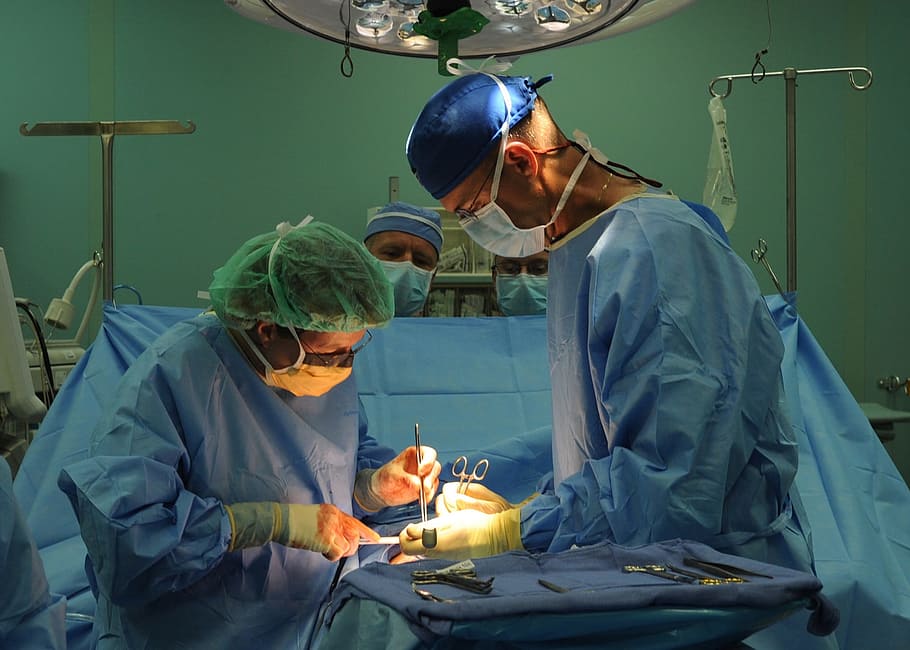 man and woman wearing surgical suits, surgery, surgeons, operation