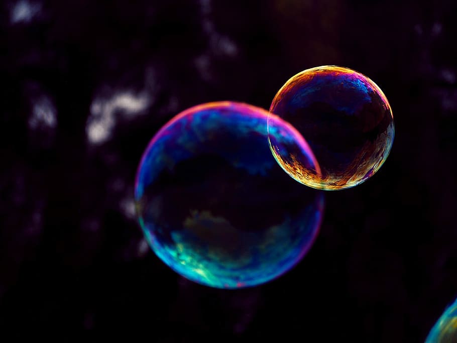 closeup photo of two bubbles, macro photography of bubbles, iridescent