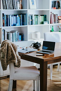 Silver laptop with various items on a table, magazines, computer HD wallpaper