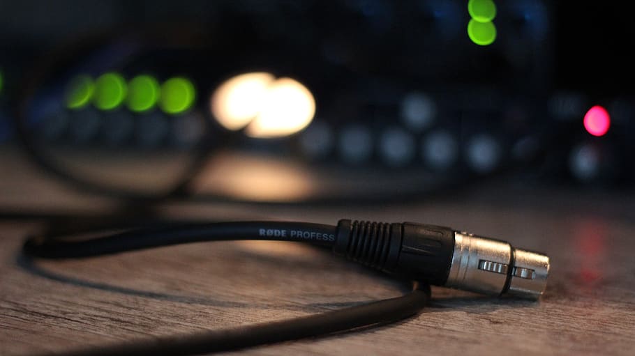 selective focus photography of black microphone cable on brown wooden surface HD wallpaper