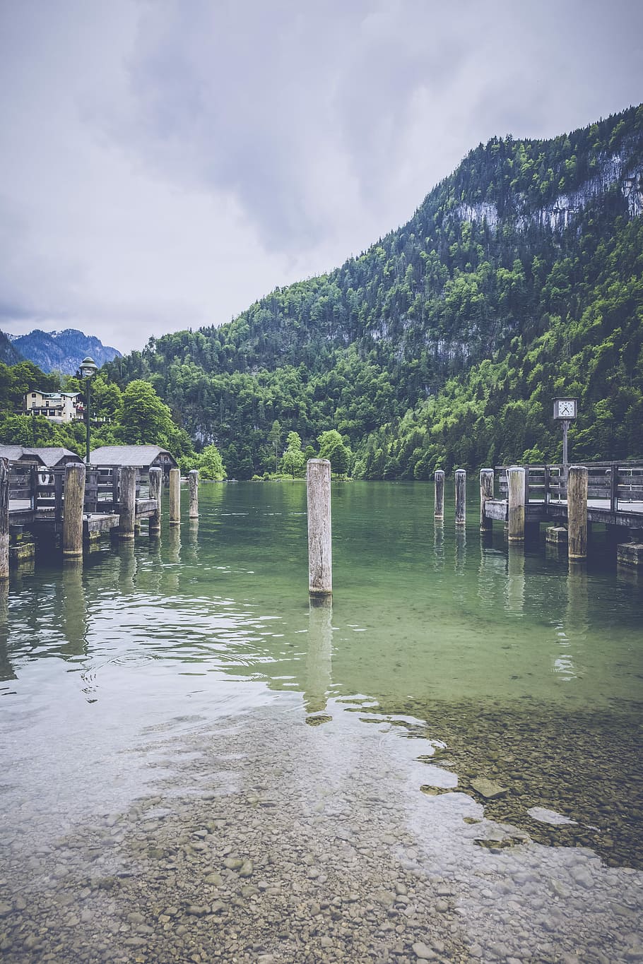 white post on body of water, white concrete post on body of water far at grass covered mountain under white clouds during daytime HD wallpaper