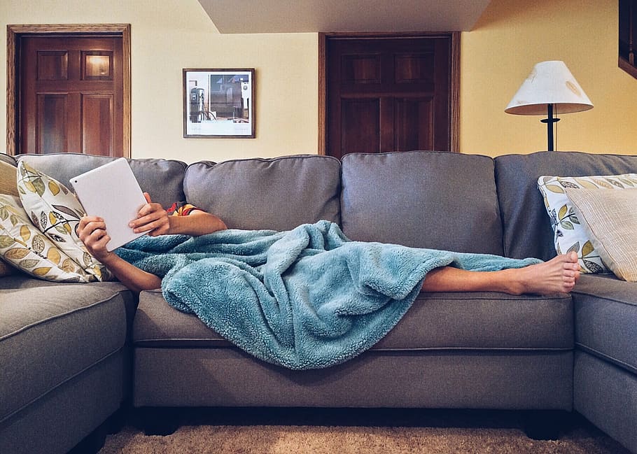 person covered with blue blanket lying on gray sofa, home, life HD wallpaper