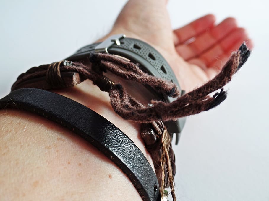 selective focus photography of person wearing brown leather adjustable bracelet and black watch HD wallpaper