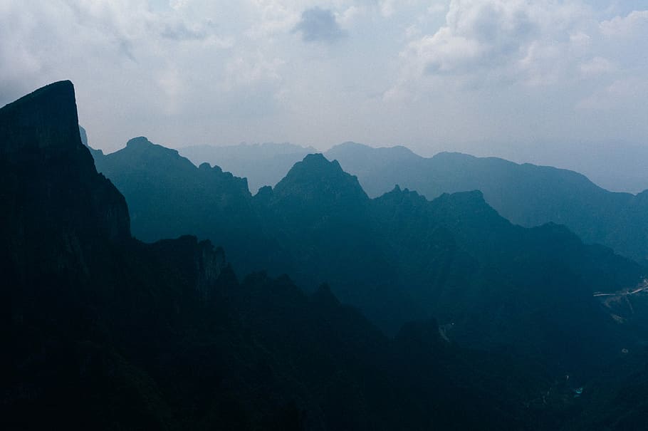 silhouette of mountains under cloudy sky, mountain range under nimbus clouds wallpaper HD wallpaper