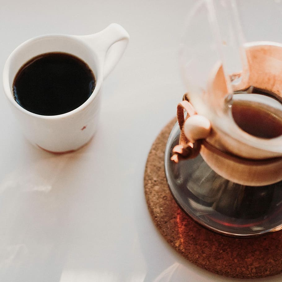 coffee mug on table, white ceramic cup with coffee near clear glass pitcher on table HD wallpaper