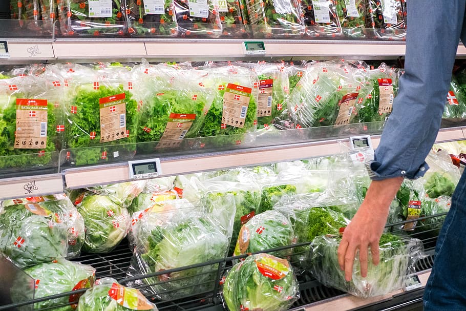 Woman picking lettuce in a grocery store, hands, healthy, people