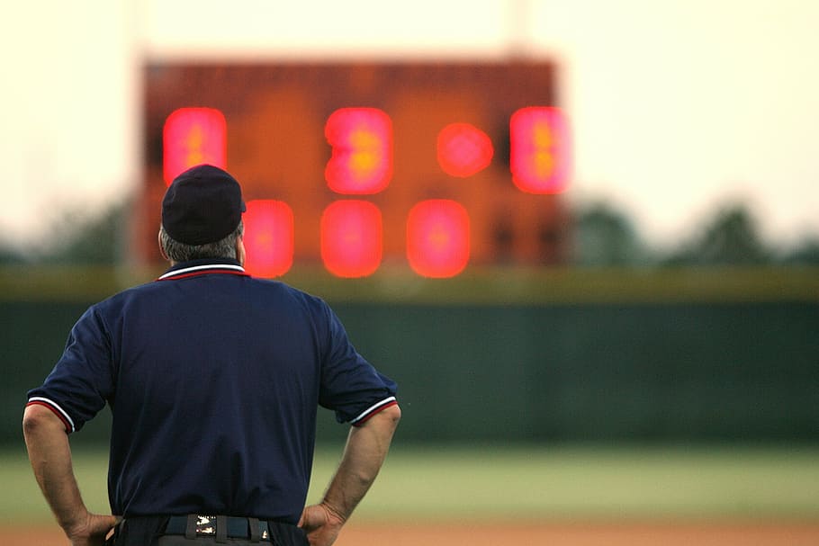 man looking at the scoreboard, umpire, sports official, baseball