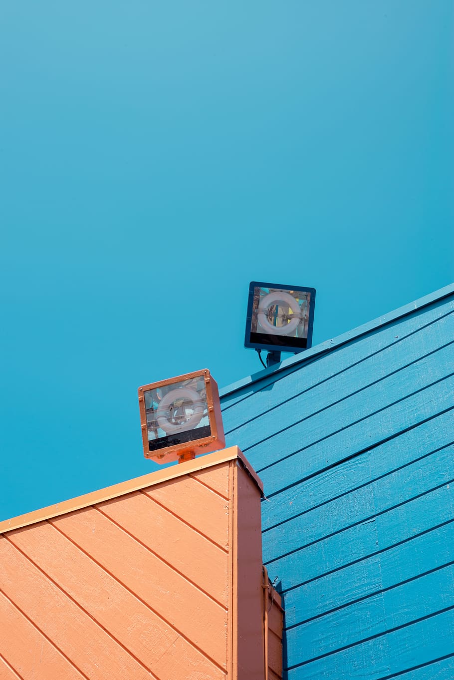 black and brown light during daytime, two LED lights, wall, blue sky HD wallpaper