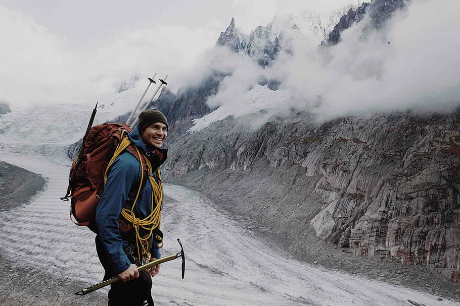 man standing near mountain at daytime, photo of man holding pick ax HD wallpaper