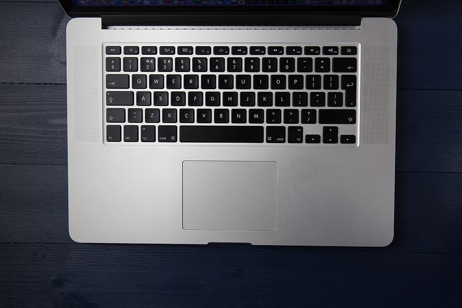 Apple laptop computer on a blue wood desk, technology, business