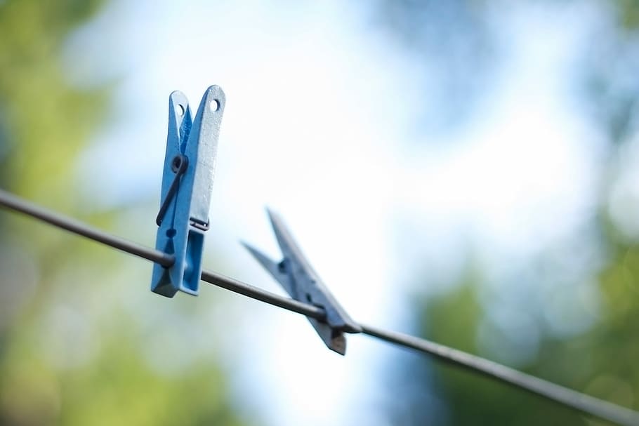 selective focus photography of blue clothes clips on black wires HD wallpaper