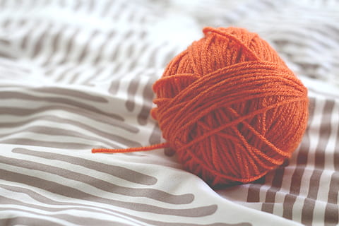 red yarn ball on top of blue and white striped textile, wool HD wallpaper