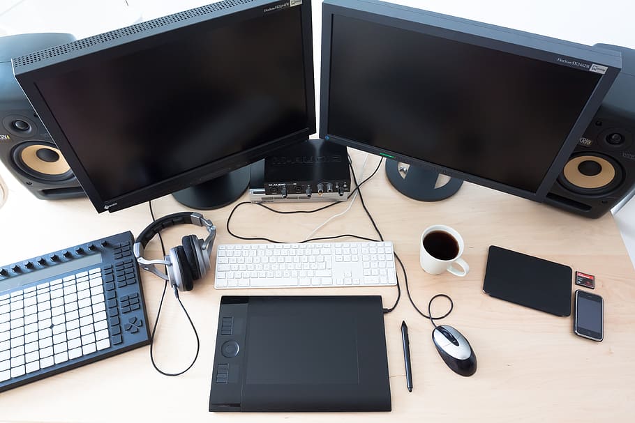 two black flat screen computer monitor on brown wooden table HD wallpaper