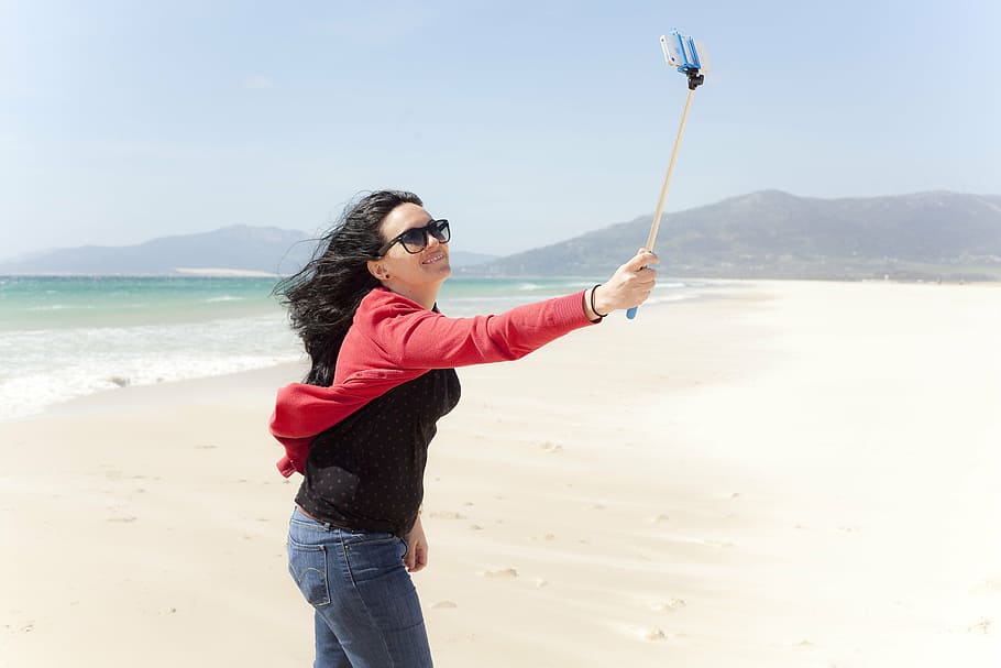 woman taking selfie using monopod front of the sea at daytime, HD wallpaper