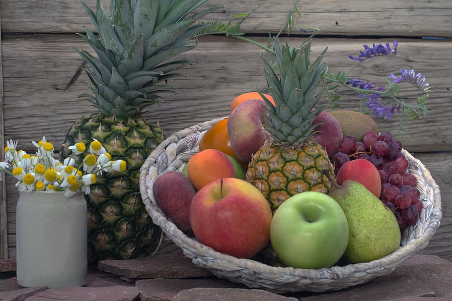 assorted fruits in brown wicker basket beside white Chrysanthemum flower centerpiece HD wallpaper