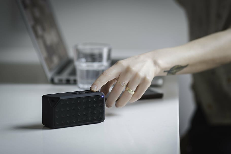 person touching speaker on white table, people, hand, ring HD wallpaper