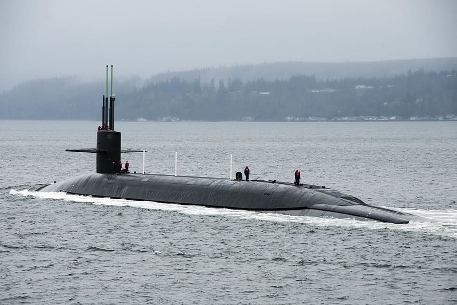 photo of black submarine under white clouds at daytime, Navy